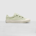 Light green sneaker with white sole on a light gray background