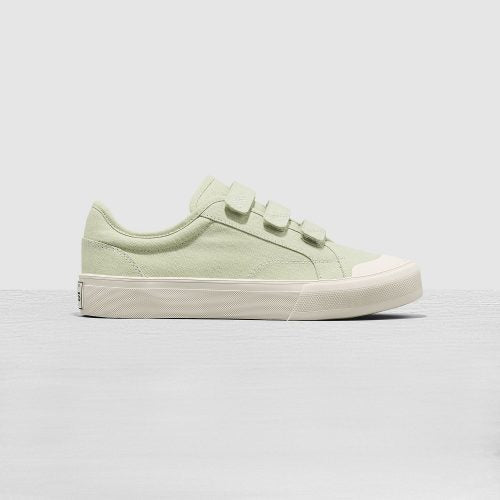 Light green sneaker with white sole on a light gray background